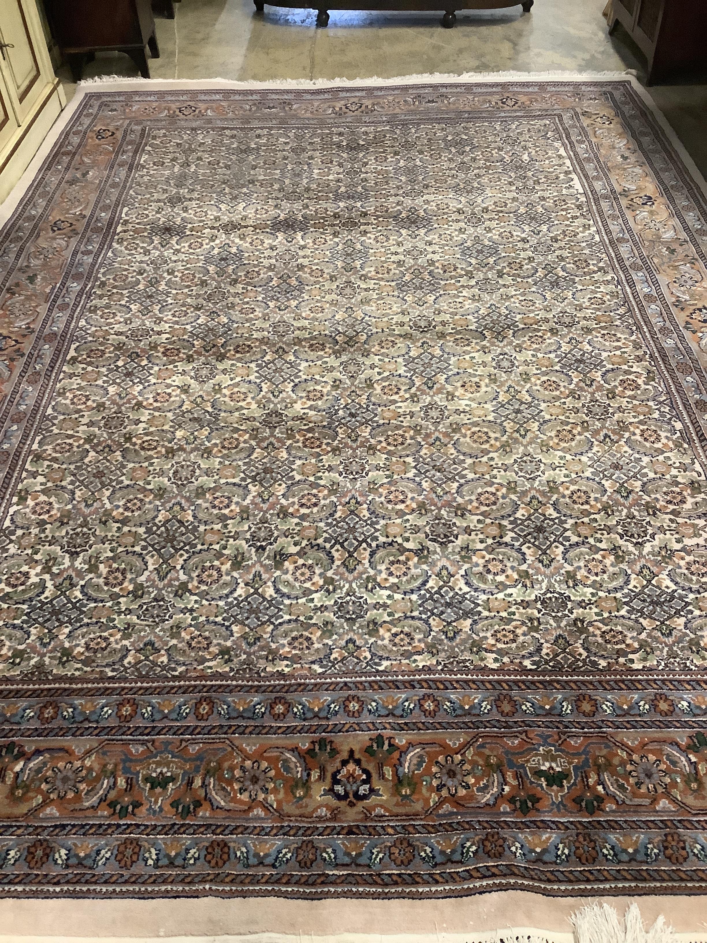 A North West Persian ivory ground carpet, 354 x 247cm